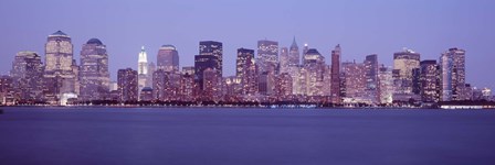 Skyscrapers lit up in Manhattan, New York City by Panoramic Images art print
