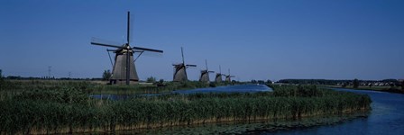 Traditional windmills at a riverbank, Kinderdijk, Rotterdam, Netherlands by Panoramic Images art print
