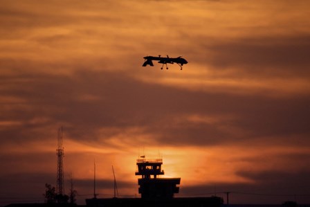 A MQ-1 Predator over COB Speicher at Sunset, Tikrit, Iraq by Terry Moore/Stocktrek Images art print